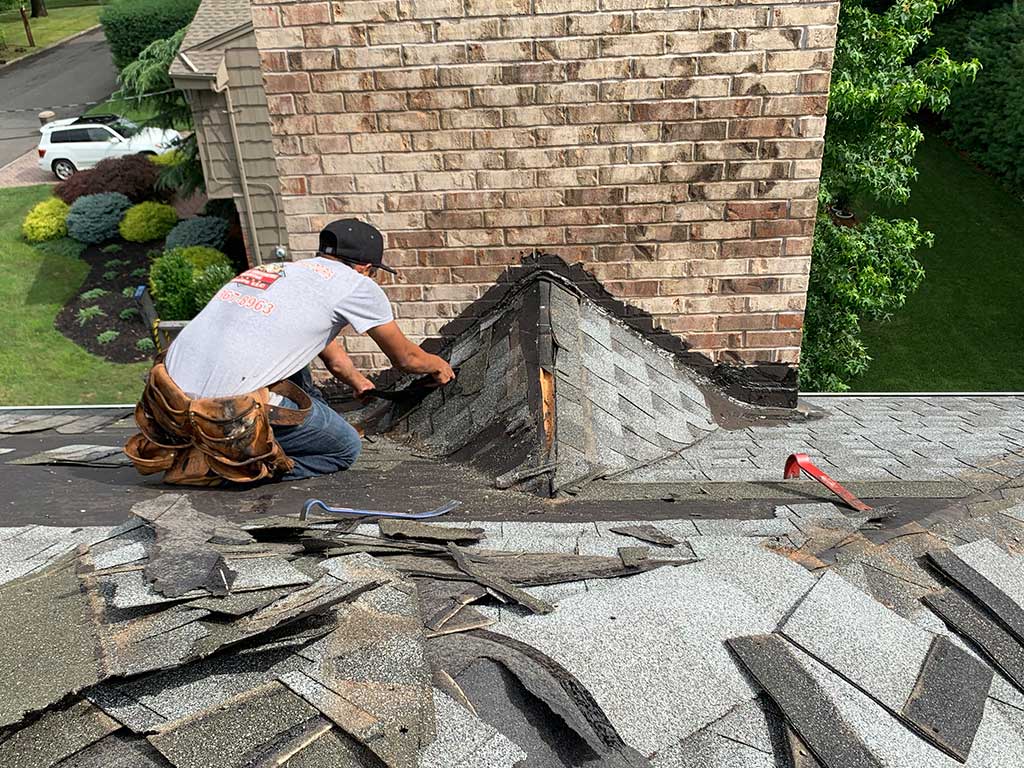 Homeowner reviewing hail insurance paperwork with a roofing expert